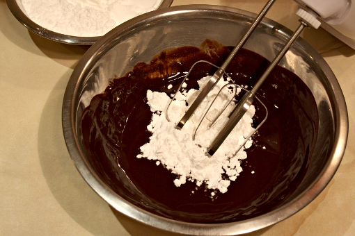 st-martins-cake-adding-sugar-to-melted-butter-and-chocolate-for-frosting