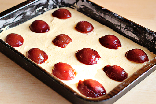 plum cake recipe with step by step picture tutorial, evenly arrange the halved plums on top of the batter