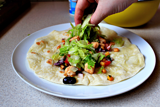 chicken burritos recipe with step by step picture instructions, prepare the tortillas according to instructions and fill them first with the vegetable mixture, then the chicken, with a little bit of lettuce, and finally with 1 tablespoon sour cream