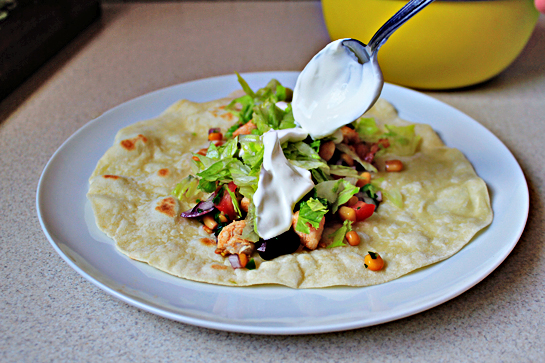 chicken burritos recipe with step by step picture instructions, prepare the tortillas according to instructions and fill them first with the vegetable mixture, then the chicken, with a little bit of lettuce, and finally with 1 tablespoon sour cream