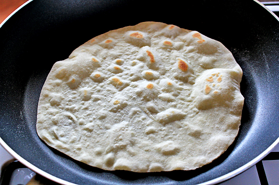 homemade tortillas recipe with step by step picture instructions, how to make homemade flour tortillas, flip the tortilla over for the second time, and let it cook for another 20 seconds