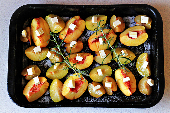 roasted summer fruit with rosemary and cream recipe with step by step pictures, sprinkle fruit with sugar, you can use more sugar if your fruit is slightly under-ripe, cube the butter and distribute it over the fruit, add the rosemary sprigs