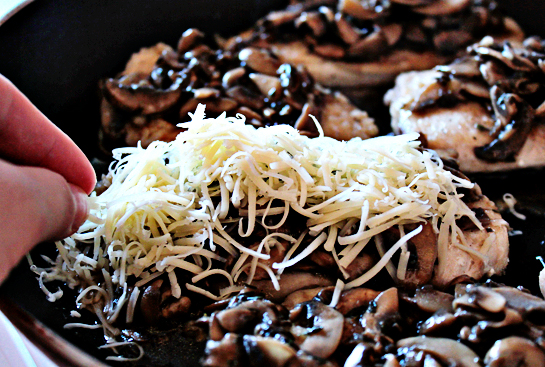 chicken with mushrooms and cheese step by step recipe with ingredients and pictures, distribute shredded cheese evenly over cooked chicken fillets covered with mushroom sauce