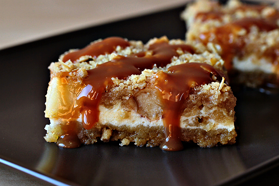 Caramel apple cheesecake cookie bars recipe with step by step pictures. Caramel apple cheesecake cookie bar on a brown plate.