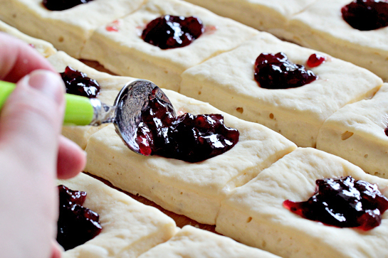 sweet jam filled buns filling the cut squares with fruit jam