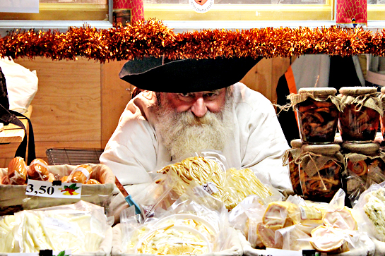 Christmas market man selling cheese products