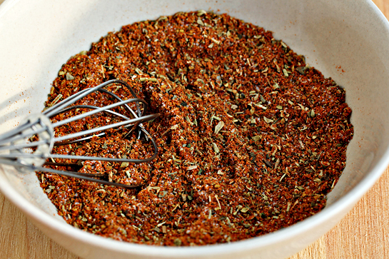 man-approved-spicy-oven-baked-french-fries-recipe-in-a-small bowl, combine the spices - chili powder, ground cumin, paprika, Italian seasoning, and salt.