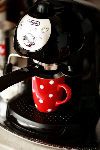 making coffee red mug with polka dots