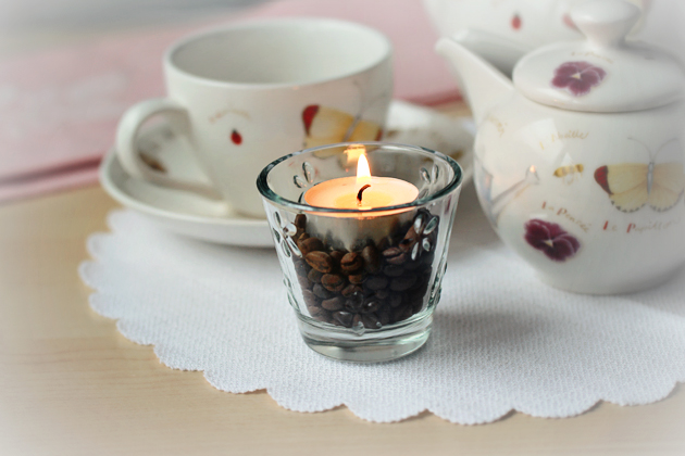candle in glass with coffee beans