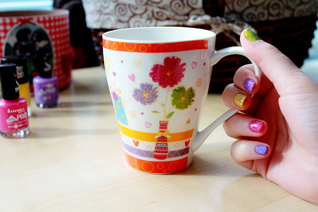 colorful mugs with flowers and nails painted with different colors