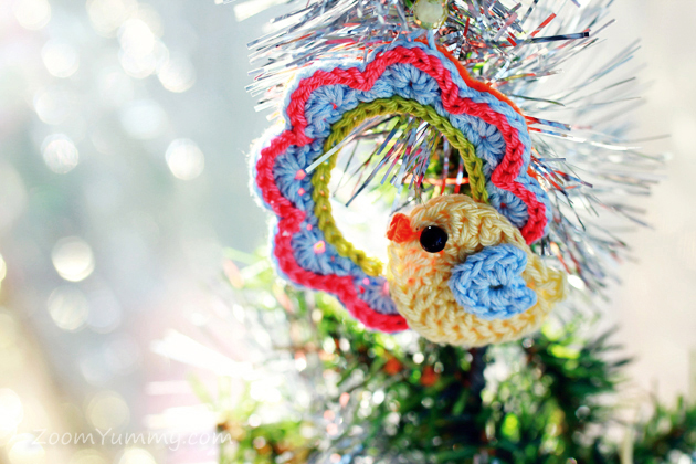 little crochet bird on a crochet wreath ornament on Christmas tree