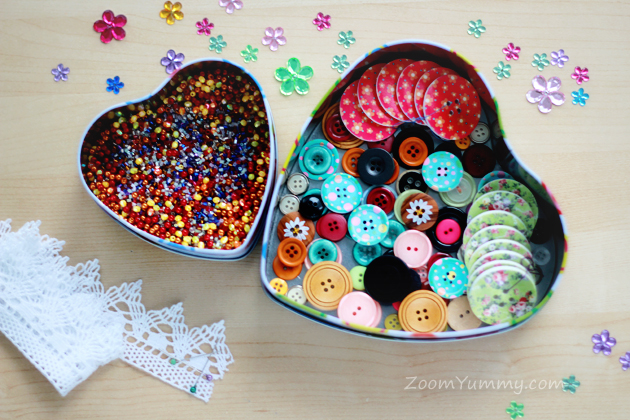 heart shaped boxes filled with beads and buttons